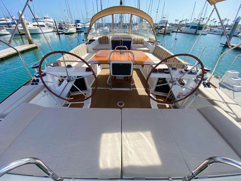 Slide: The Image of Luxurious 2014 Jeanneau 57 yacht interior with dual steering wheels in a marina setting. - 19
