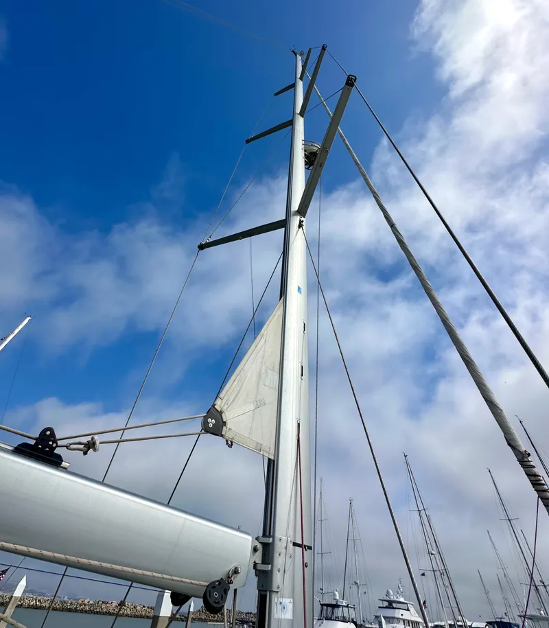 Slide: The Image of Mast of 2014 Jeanneau 57 sailboat against a cloudy blue sky. - 41