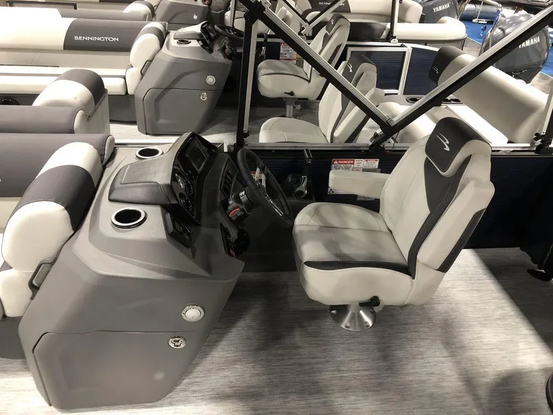 Slide: The Image of 2025 Bennington S Quad Bench 20 SSR boat interior with helm and seating. - 3