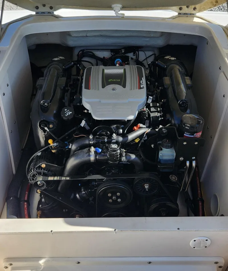 Slide: The Image of 2015 Chaparral 226 SSi boat engine compartment, showcasing a powerful inboard motor. - 12