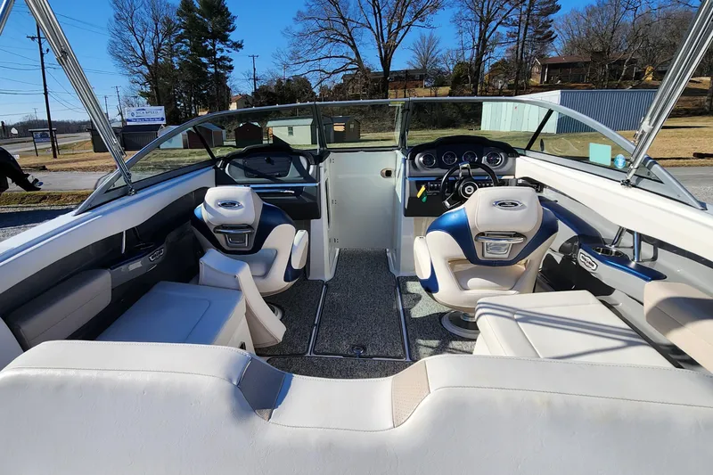 Slide: The Image of 2015 Chaparral 226 SSi boat interior with dual captain seats and dashboard view. - 6