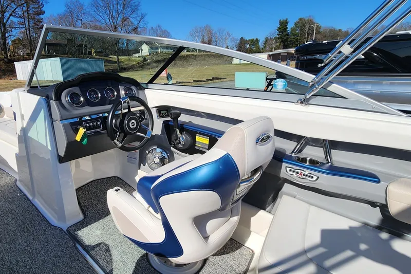 Slide: The Image of Interior view of 2015 Chaparral 226 SSi boat, featuring sleek dashboard and comfortable seating. - 8