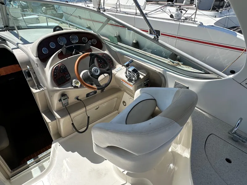 Slide: The Image of 2009 Sea Ray 280 Sundancer helm with steering wheel and control panel. - 13