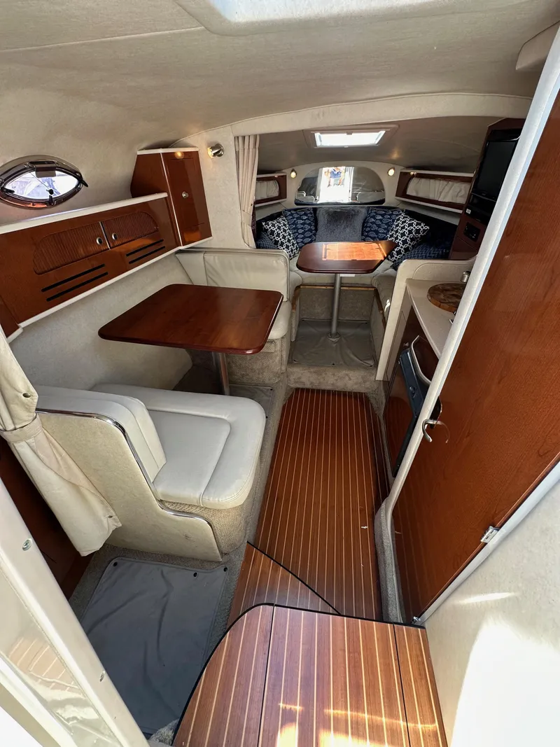 Slide: The Image of Interior of 2009 Sea Ray 280 Sundancer with wood accents and seating area. - 17