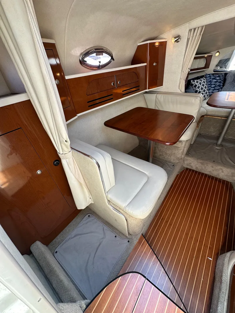 Slide: The Image of 2009 Sea Ray 280 Sundancer cabin interior with wood accents and seating area. - 18
