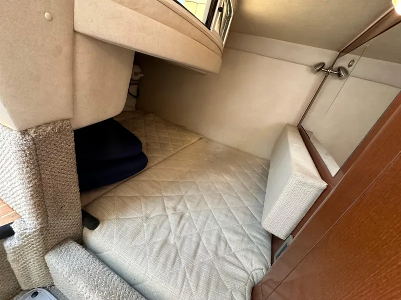 Slide: The Image of Cozy cabin interior of 2009 Sea Ray 280 Sundancer with quilted bedding. - 31
