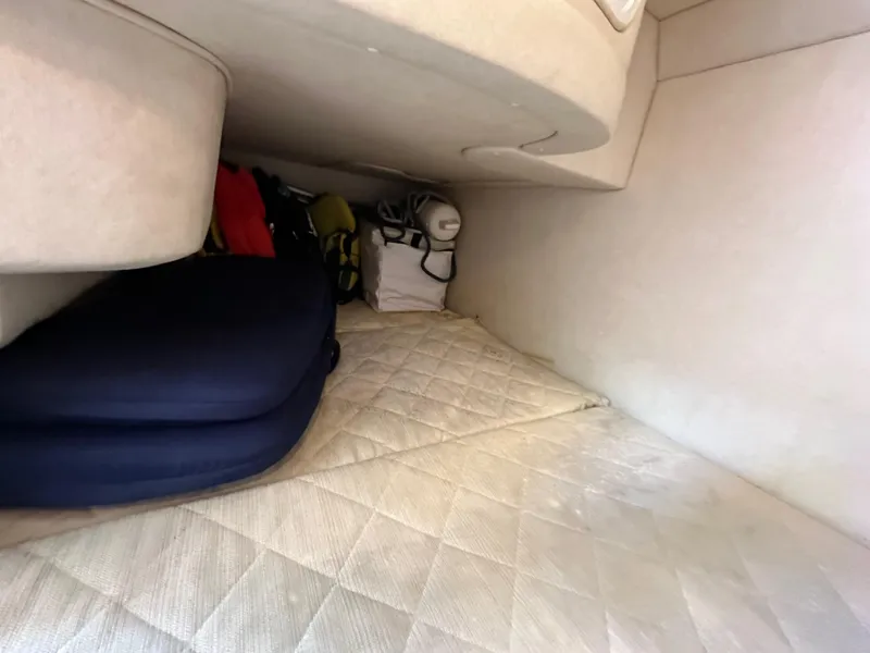 Slide: The Image of Interior cabin of 2009 Sea Ray 280 Sundancer with storage and bedding. - 32
