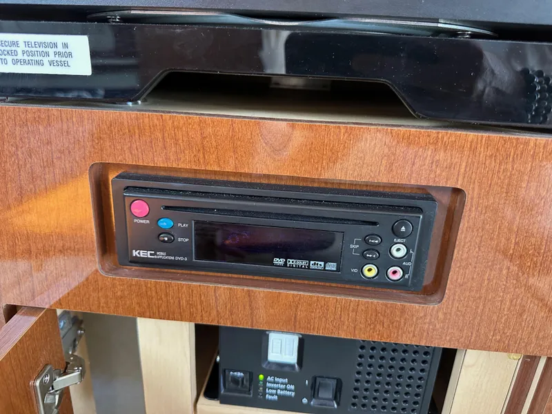 Slide: The Image of Control panel inside 2009 Sea Ray 280 Sundancer boat, featuring wood finish and electronic controls. - 35