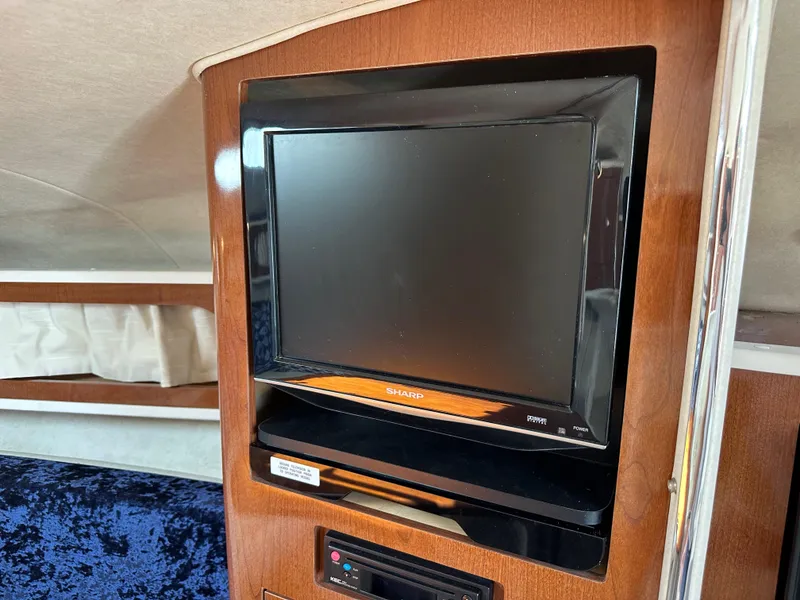 Slide: The Image of Flat-screen TV in 2009 Sea Ray 280 Sundancer cabin, mounted on wooden panel. - 36