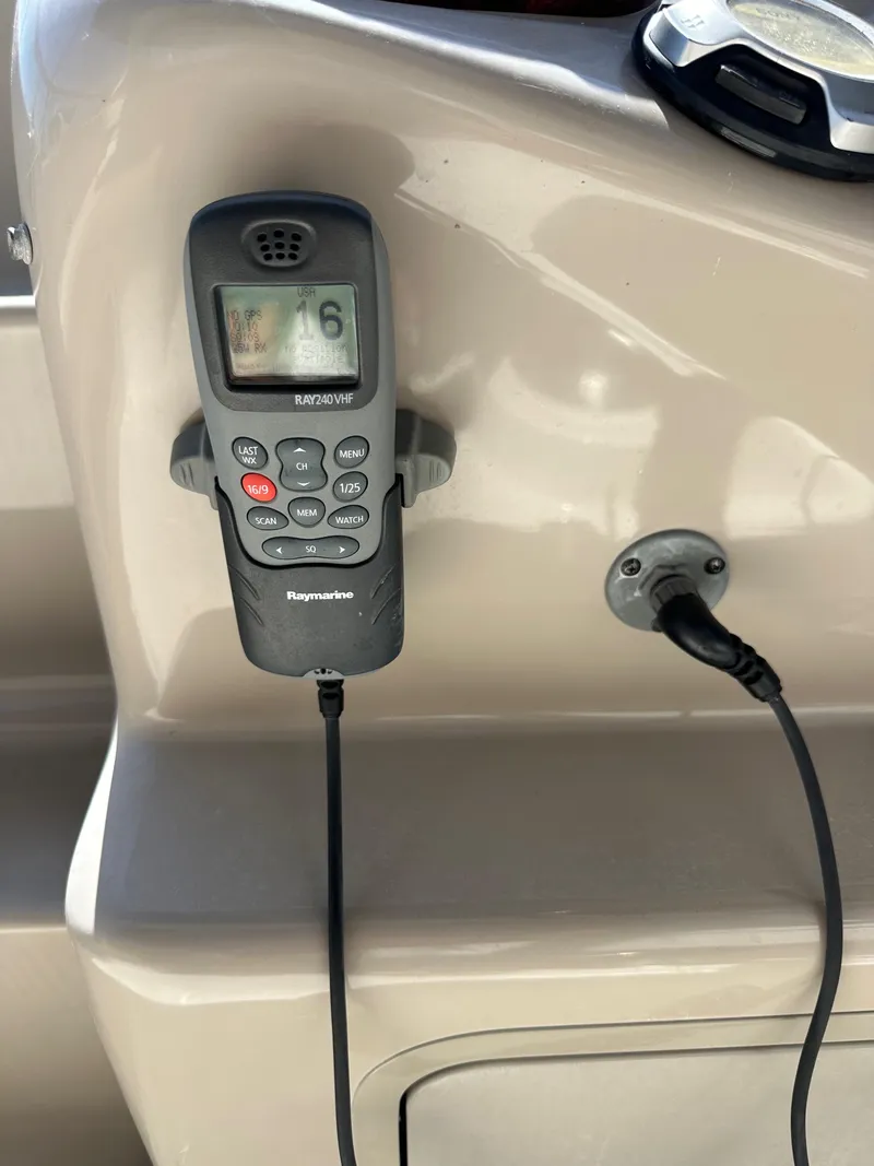 Slide: The Image of VHF radio on 2009 Sea Ray 280 Sundancer boat dashboard. - 37