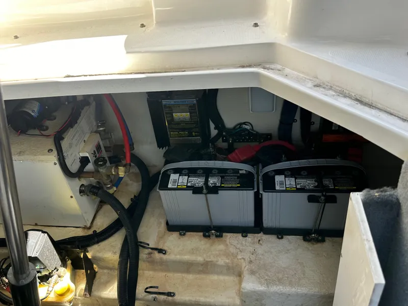 Slide: The Image of Engine compartment of 2009 Sea Ray 280 Sundancer with visible batteries and wiring. - 43