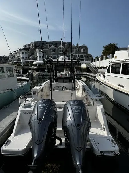 Slide: The Image of 2022 Robalo R272 boat with dual engines docked in a marina. - 5