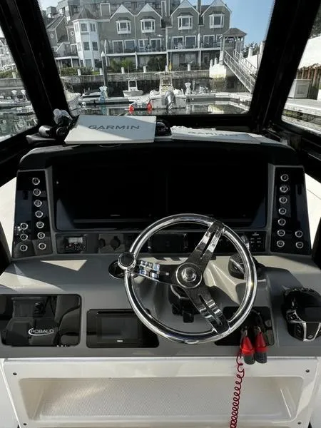 Slide: The Image of 2022 Robalo R272 boat dashboard with Garmin navigation, docked at marina. - 6