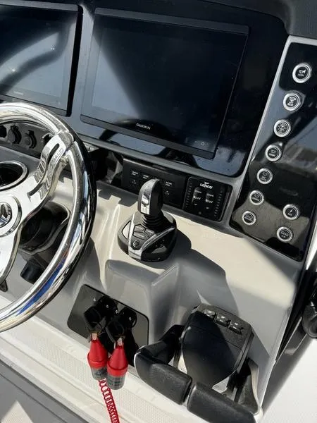 Slide: The Image of 2022 Robalo R272 boat dashboard with steering wheel and electronic controls. - 7