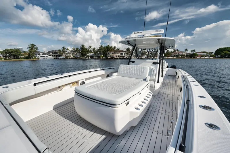 Slide: The Image of 2018 Invincible 40 Catamaran on water, showcasing spacious deck and seating. - 14