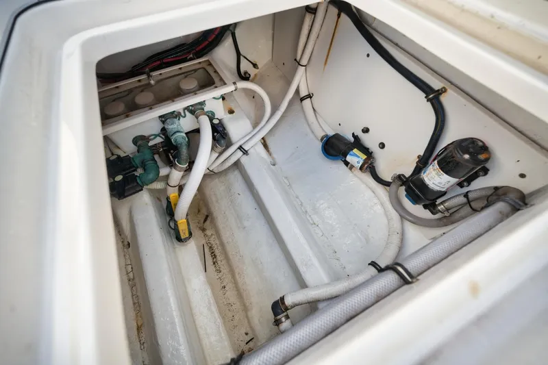 Slide: The Image of Engine compartment of 2018 Invincible 40 Catamaran, showcasing hoses and mechanical components. - 16