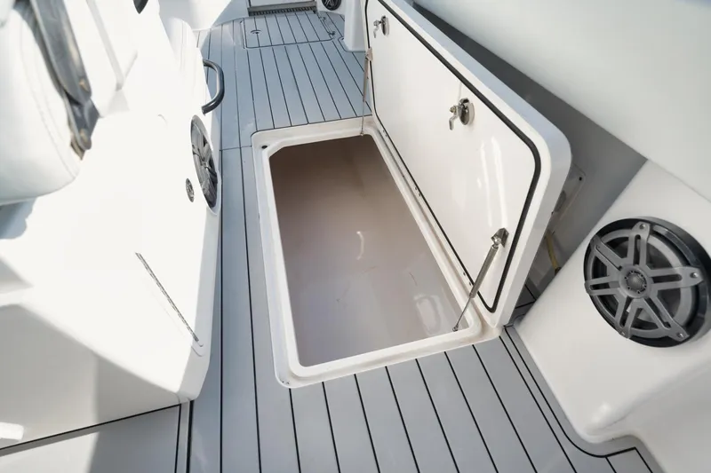 Slide: The Image of Open storage compartment on 2018 Invincible 40 Catamaran deck, featuring sleek design and speakers. - 17