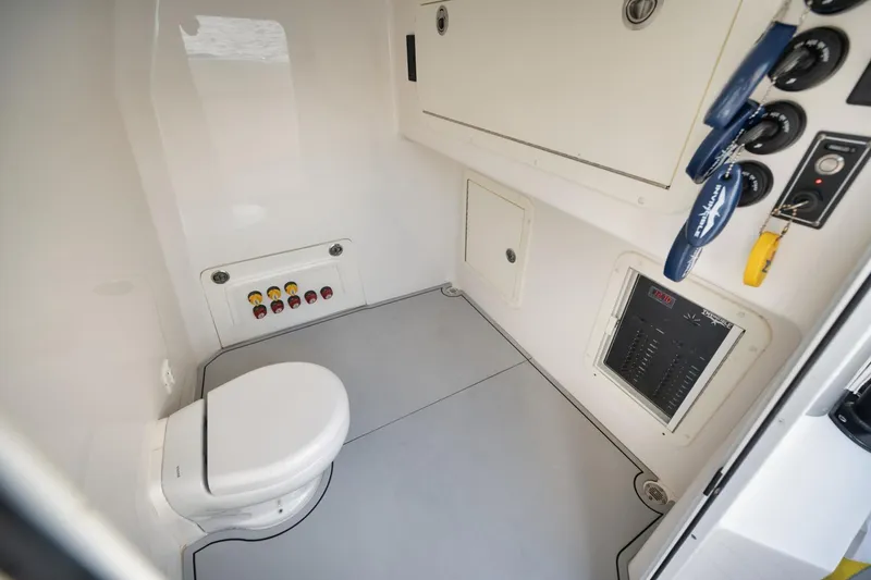 Slide: The Image of Interior of 2018 Invincible 40 Catamaran showing compact marine bathroom with controls. - 20