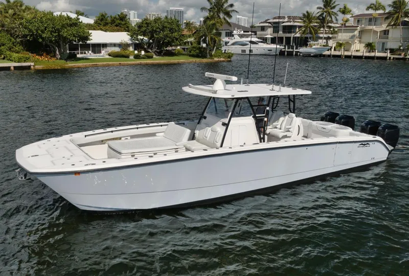 Slide: The Image of 2018 Invincible 40 Catamaran on water, sleek design, spacious deck, modern coastal setting. - 22