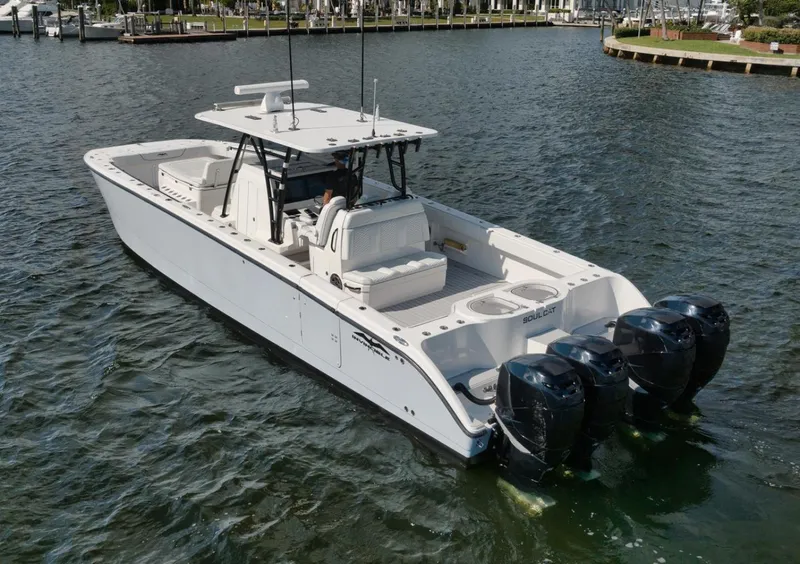 Slide: The Image of 2018 Invincible 40 Catamaran with quad engines cruising in a marina. - 23