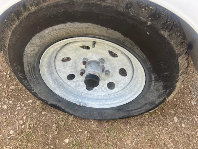 Slide: The Image of Flat tire on a 2004 Key West 196 Bay Reef trailer, parked on gravel. - 11