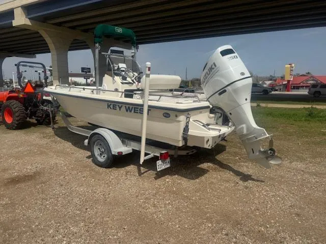 Slide: The Image of 2004 Key West 196 Bay Reef boat on trailer under bridge. - 3