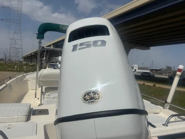 Slide: The Image of 2004 Key West 196 Bay Reef boat with 150 horsepower engine under a bridge. - 6