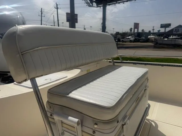 Slide: The Image of 2004 Key West 196 Bay Reef boat seat, white upholstery, outdoor setting. - 9