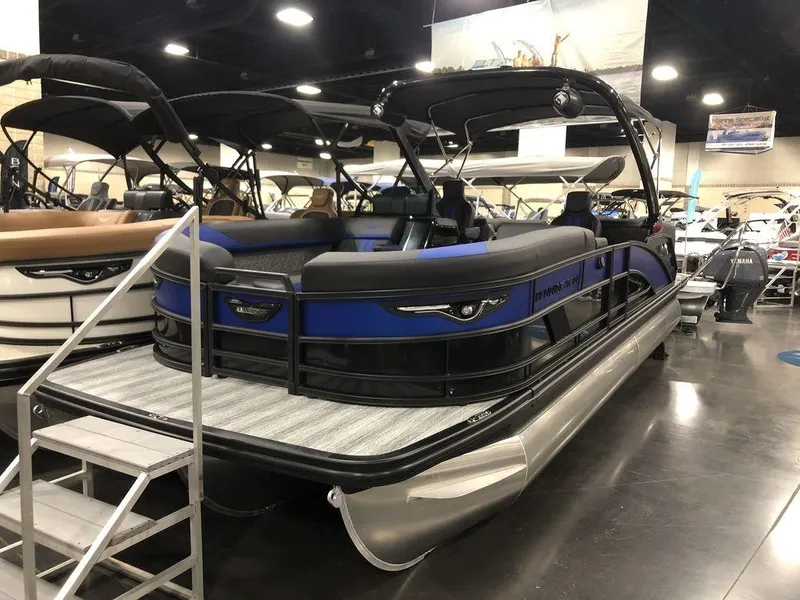 The Image of 2025 Bennington M Quad Bench 24 MFB pontoon boat displayed indoors. - 1