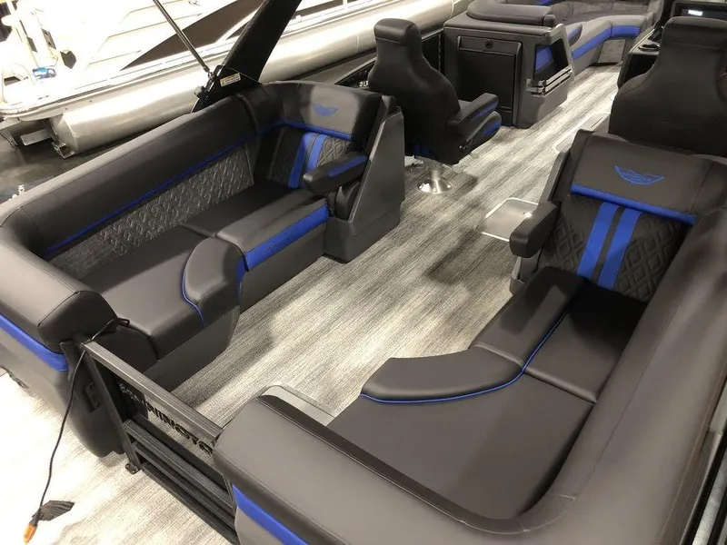 Slide: The Image of 2025 Bennington M Quad Bench 24 MFB interior with sleek black and blue seating. - 12