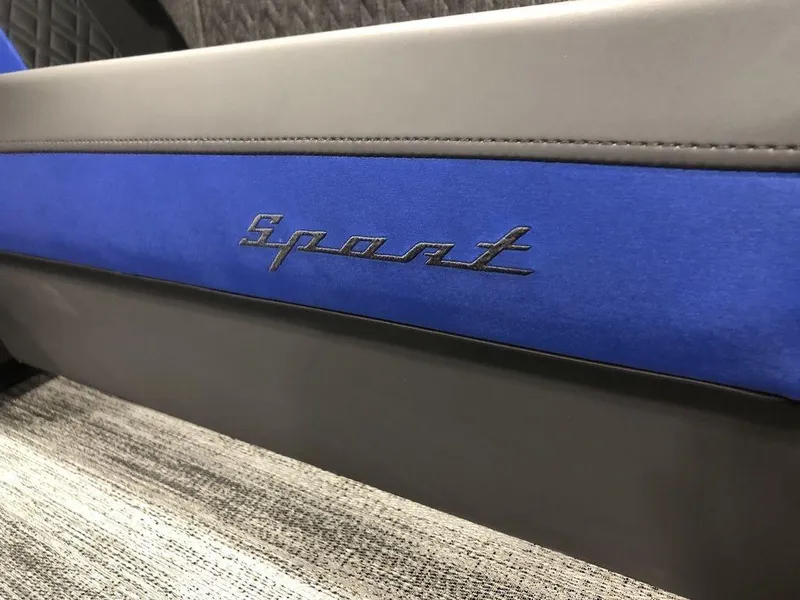Slide: The Image of 2025 Bennington M Quad Bench 24 MFB with "Sport" logo on blue and gray upholstery. - 4