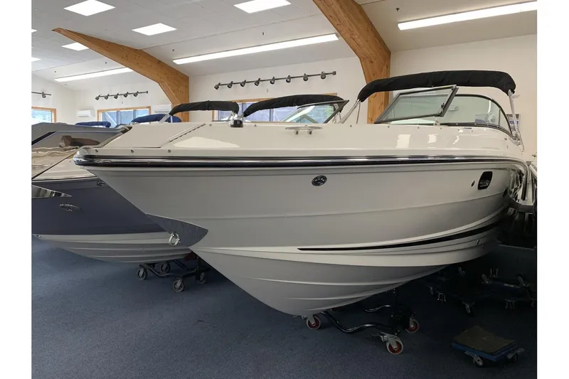 Slide: The Image of 2020 Sea Ray 280 SLX boat displayed indoors on a showroom floor. - 1