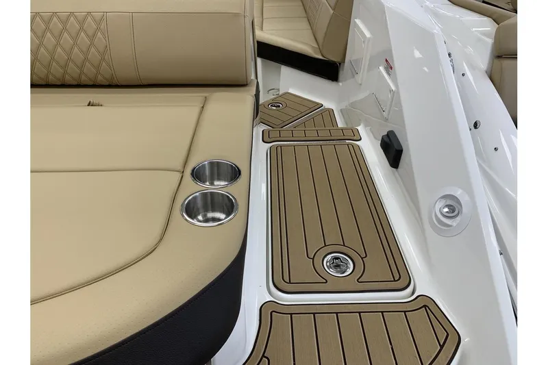 Slide: The Image of 2020 Sea Ray 280 SLX interior with tan seating and cup holders. - 10