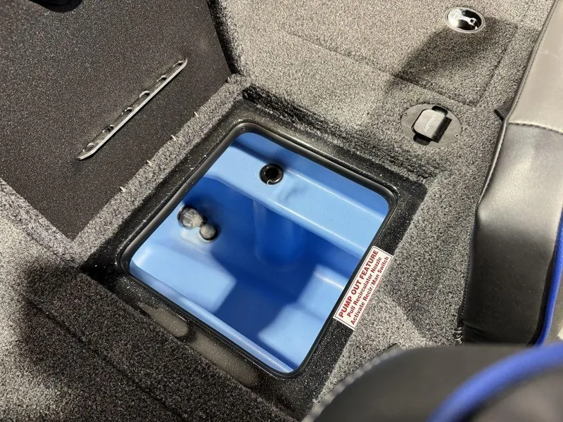 Slide: The Image of 2022 Nitro Z19 Pro boat storage compartment with blue interior and carpeted edges. - 25