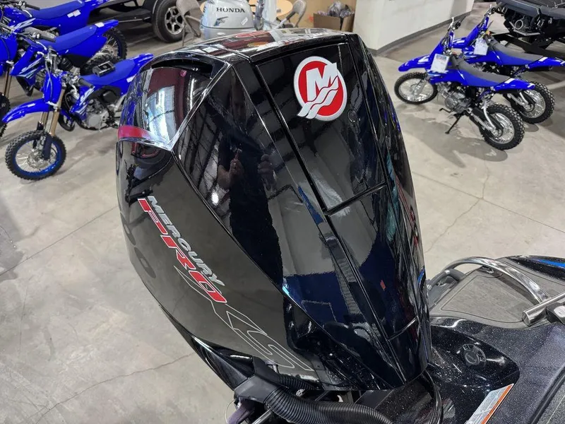 Slide: The Image of 2022 Nitro Z19 Pro outboard motor in showroom with blue bikes in background. - 29