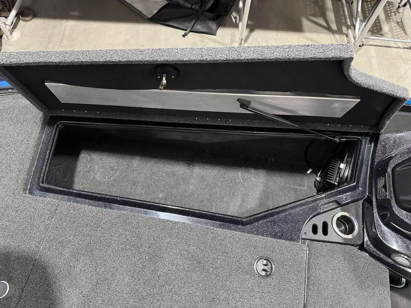 Slide: The Image of 2022 Nitro Z19 Pro boat storage compartment with open lid and carpeted interior. - 31