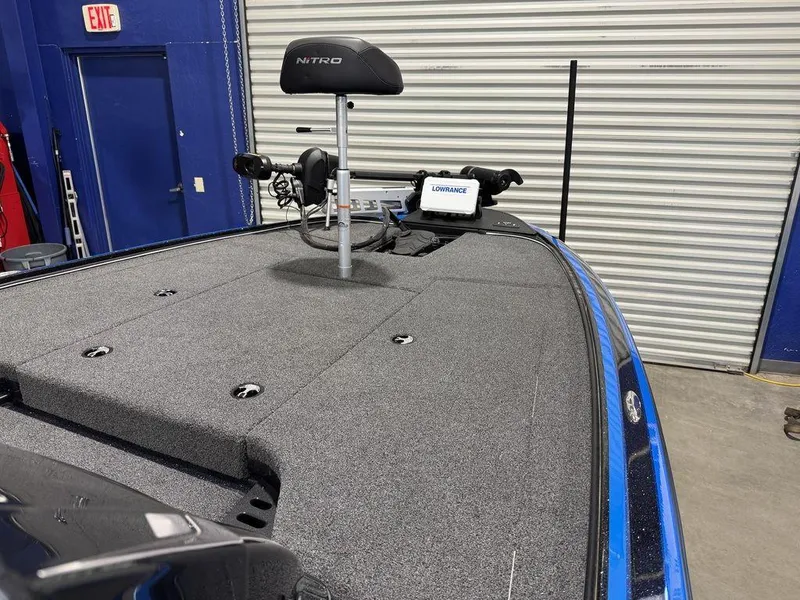Slide: The Image of 2022 Nitro Z19 Pro boat deck with fishing equipment in a garage setting. - 49