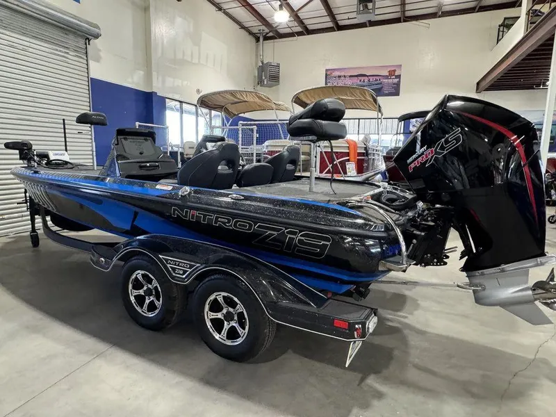 Slide: The Image of 2022 Nitro Z19 Pro boat in showroom, featuring sleek design and powerful engine. - 5