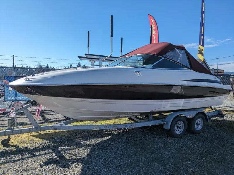 Slide: The Image of 2002 Maxum 2100 SC boat on trailer with maroon canopy, displayed outdoors. - 1