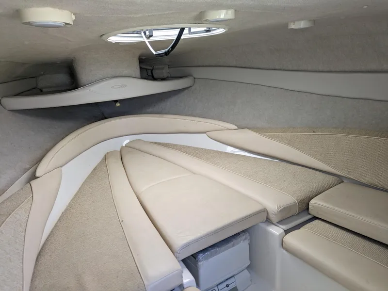 Slide: The Image of 2002 Maxum 2100 SC boat interior with beige seating and storage compartments. - 11