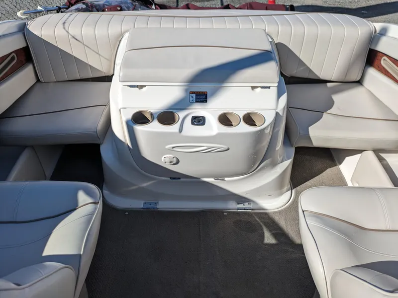 Slide: The Image of 2002 Maxum 2100 SC boat interior with beige seating and cup holders. - 12