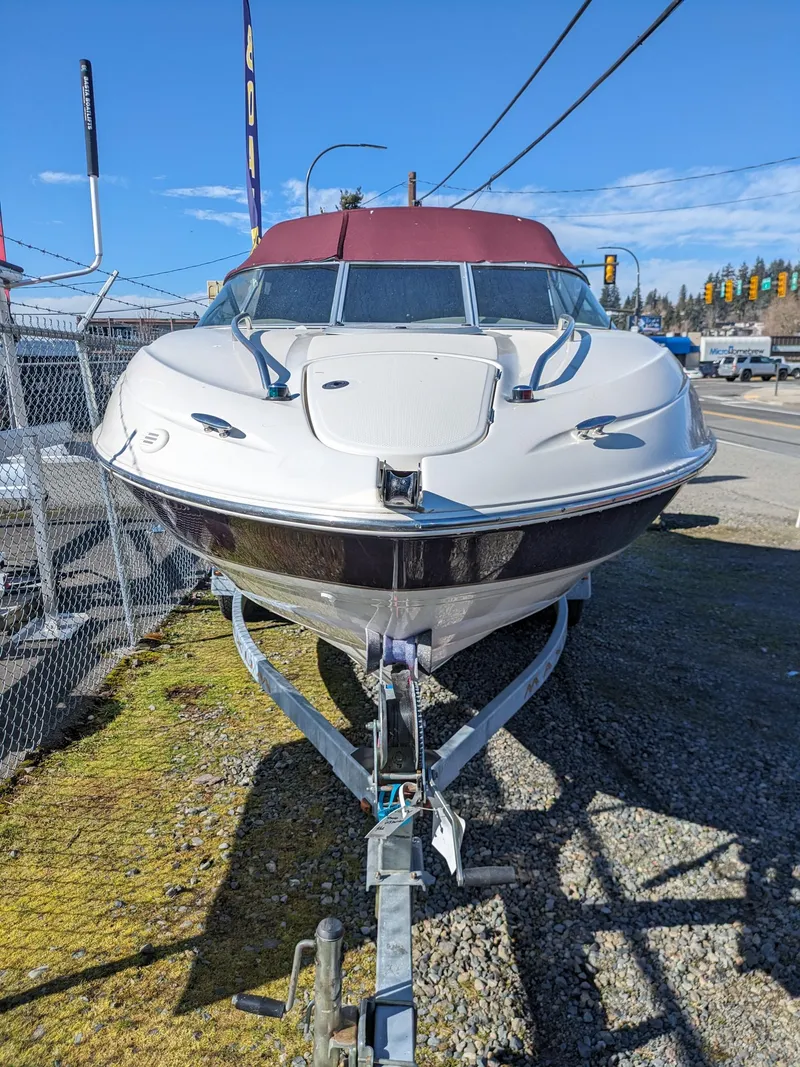Slide: The Image of 2002 Maxum 2100 SC boat on trailer, parked outdoors, sunny day. - 13