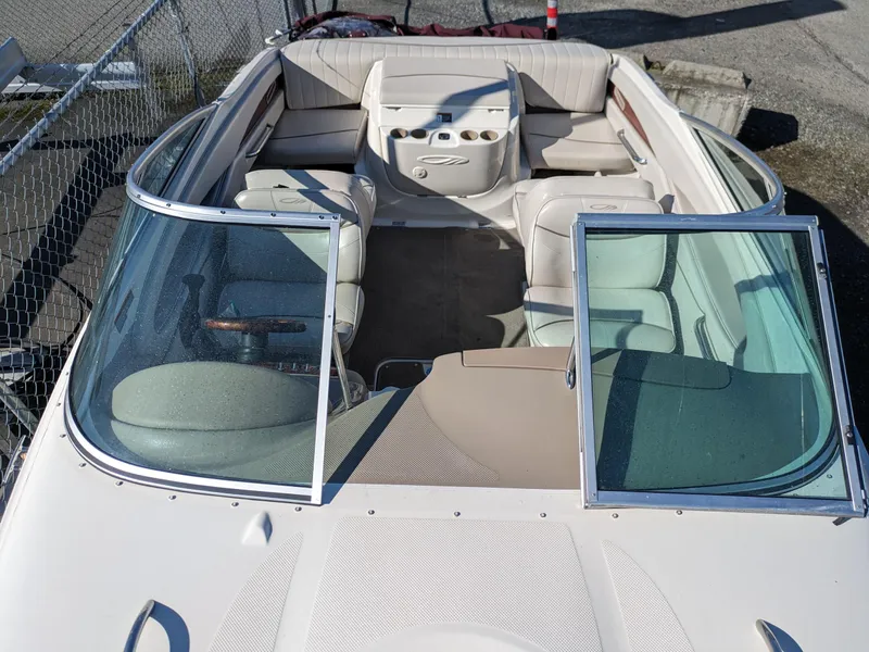 Slide: The Image of 2002 Maxum 2100 SC boat interior with beige seating and open windshield. - 17
