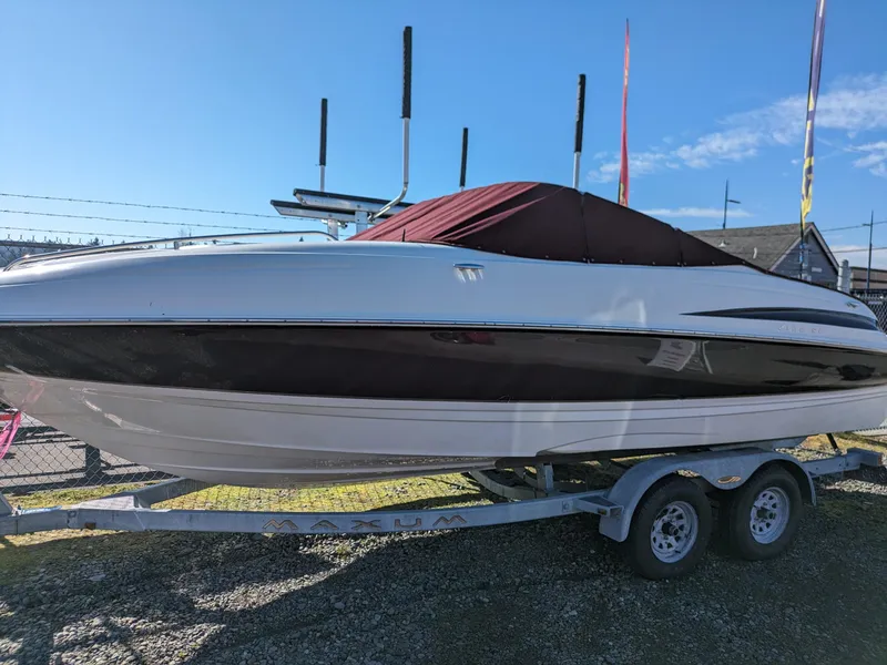 Slide: The Image of 2002 Maxum 2100 SC boat on trailer, covered, under clear blue sky. - 4
