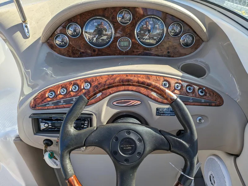 Slide: The Image of Dashboard of a 2002 Maxum 2100 SC boat with wood accents and gauges. - 5