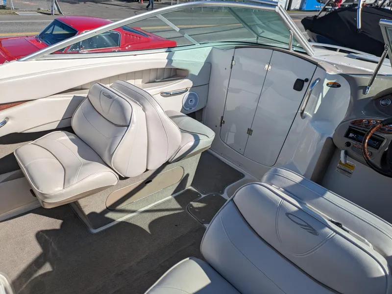 Slide: The Image of 2002 Maxum 2100 SC boat interior with white leather seats and dashboard. - 7
