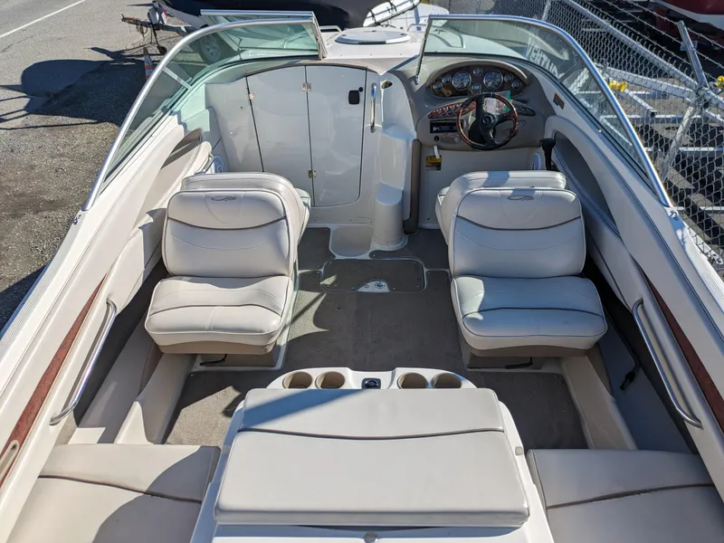 Slide: The Image of 2002 Maxum 2100 SC boat interior with beige seating and steering wheel. - 8