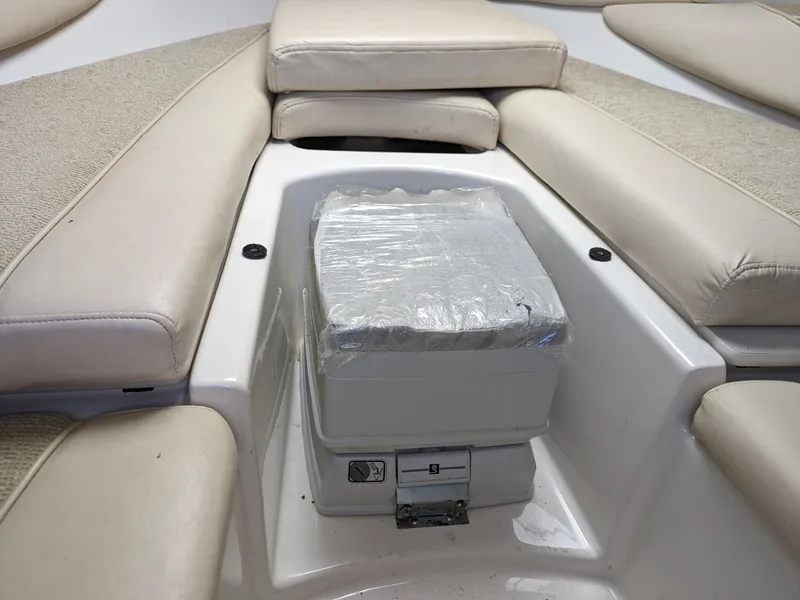 Slide: The Image of 2002 Maxum 2100 SC boat interior with cushioned seating and storage compartment. - 9