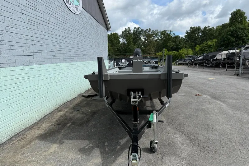 Slide: The Image of 2025 SeaArk 2472 Workhorse 240 boat on trailer, parked outdoors near a building. - 10