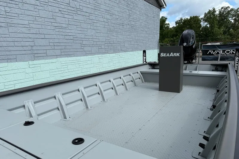 Slide: The Image of 2025 SeaArk 2472 Workhorse 240 boat, spacious interior, sturdy design, outdoor setting. - 13